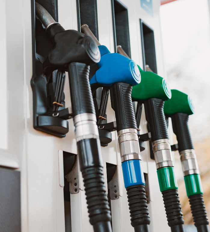 A row of fuel pump nozzles at a filling station
